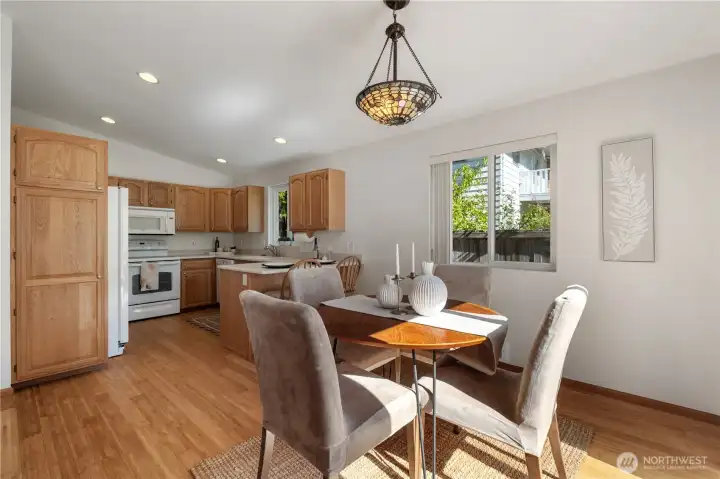 View from the dining area into the adjacent kitchen. The kitchen pantry cabinet adds to the large amount of storage contained within the kitchen.
