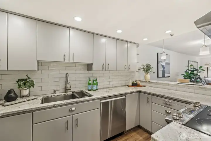 Beautifully Updated Kitchen with Quartz Counters, Tile Backsplash, and LVP Flooring