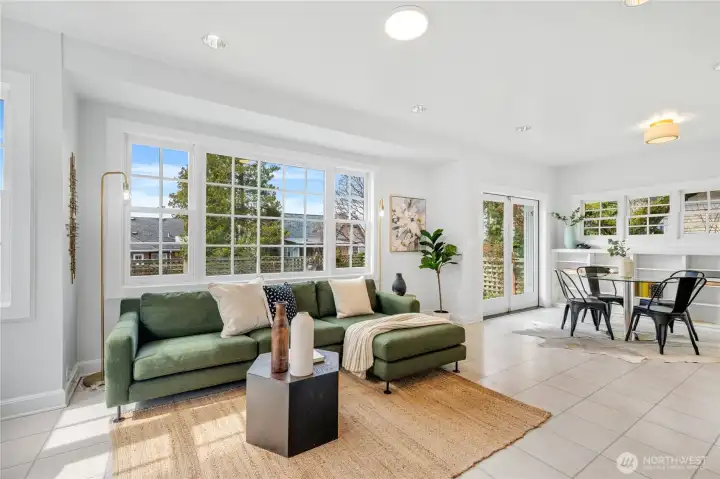 A later addition to the home, the back sunroom opens off the dining room and connects seamlessly to the breakfast nook and kitchen. Oversized south and west facing windows and French doors to the fully fenced backyard fill the space with light.