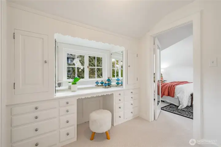 Walk-in closet/room off the primary suite with a built-in desk with drawers and two additional closets, which opens directly to the immaculately maintained and updated bathroom.