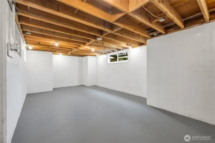 Former owners’ basement workshop with ample lighting, good ceiling height, a window, and updated electrical.