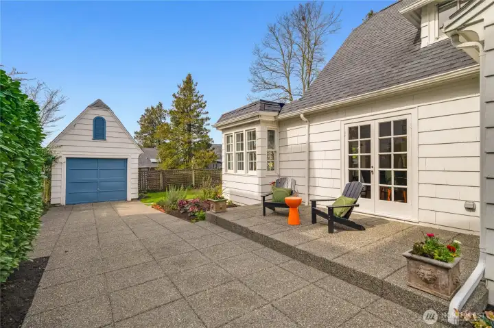 Ample off-street parking for up to four cars behind a secure gate, with a south-facing patio accessible from both the living and dining rooms.