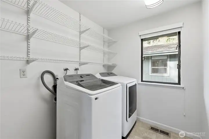 Laundry right by the half bath, pantry, and garage entry.