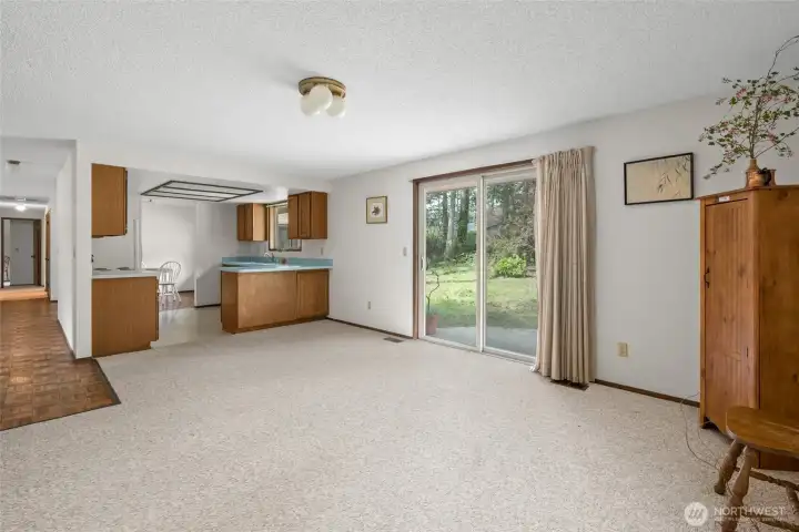 Family room opens to kitchen with room for eat in bar at the kitchen counter.