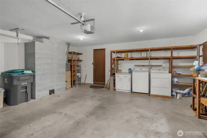 Two car attached garage with laundry and built in shelves.