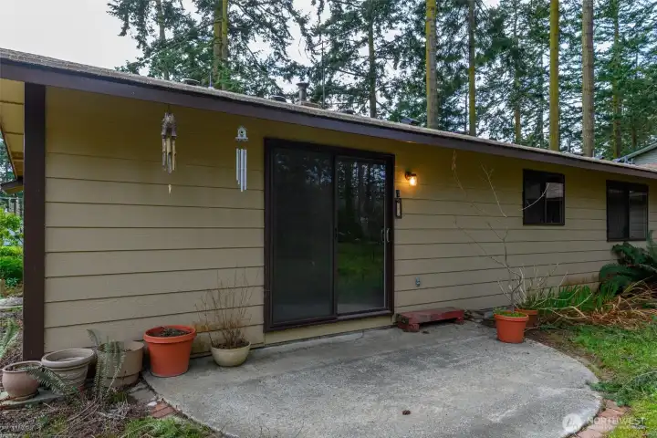 Backyard patio with sliding glass doors into family room