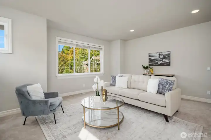 This additional view of the spacious bonus room showcases its bright, open feel, with large windows framing beautiful views of the surrounding greenery and abundant natural light filling every corner. The generous square footage and neutral finishes provide a true blank canvas, ready to be tailored to whatever space your lifestyle demands.