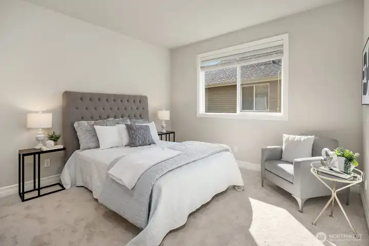 This beautifully appointed secondary bedroom offers a bright and restful retreat, featuring plush carpeting, a large window with lovely natural light, and a neutral palette that creates a warm and inviting atmosphere. Generous in size and thoughtfully designed, this room is equally well-suited for family members, guests, or a variety of flexible living arrangements.
