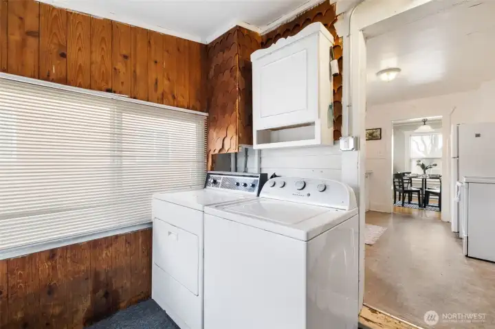 Laundry room off the kitchen with access to the back