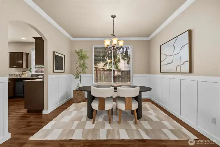 Dining room with crown molding and elegant wainscoting