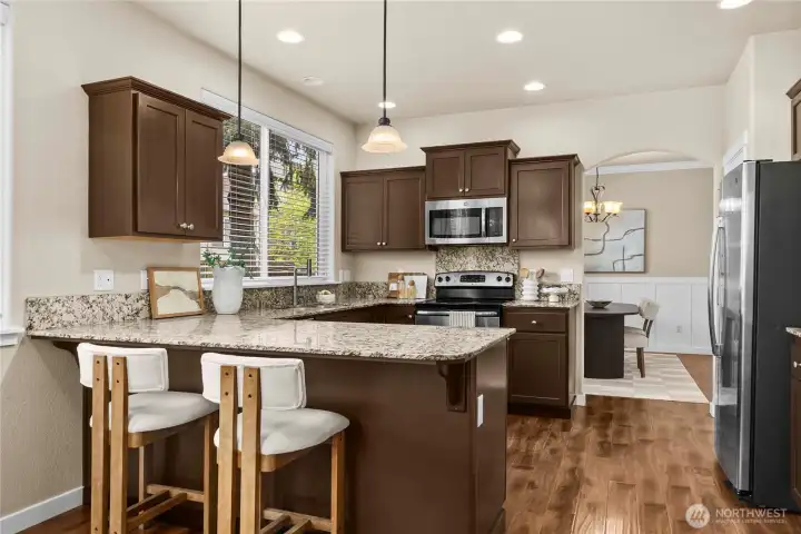 The kitchen features granite counters...