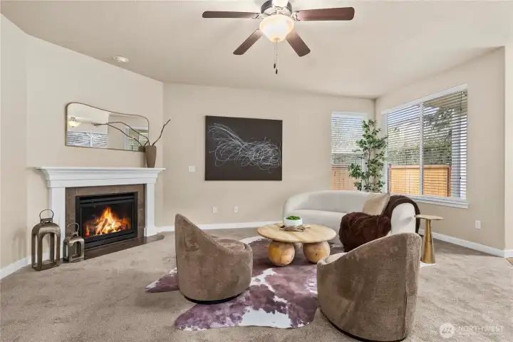 Note the white trimwork, gas fireplace and ceiling fan
