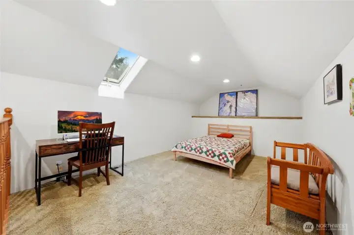 Upper-level loft for additional living or workspace.