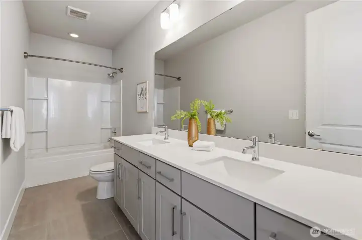 Bathroom with double sink and shower/tub combo