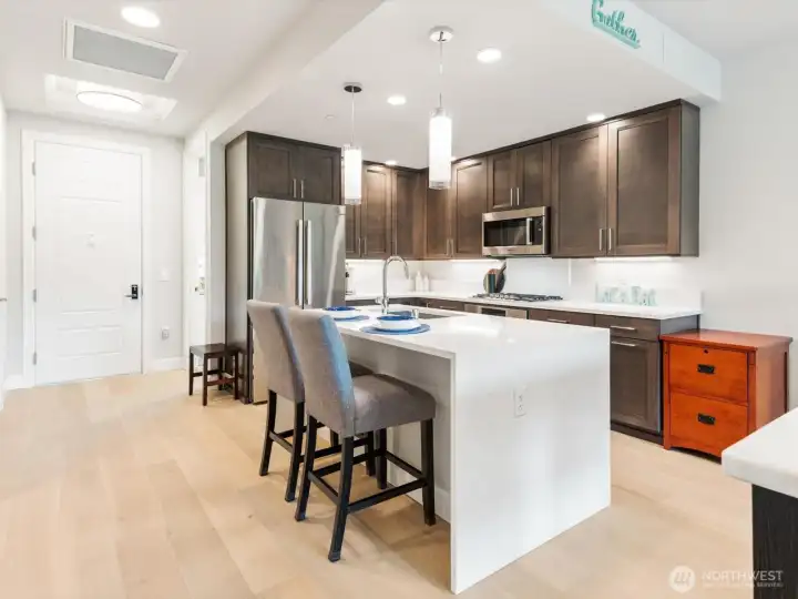 Whip up delicious meals from the kitchen featuring quartz counters, premium Bosch appliances, abundant storage & oversized island. Whip up delicious meals from the kitchen featuring quartz counters, premium Bosch appliances, abundant storage & oversized island.
