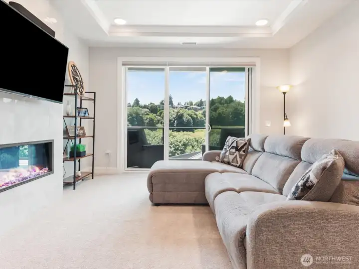 Great room with linear fireplace and expansive windows framing peaceful views. Great room with linear fireplace and expansive windows framing peaceful views.