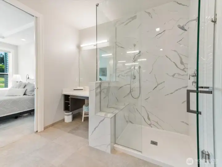 Primary bedroom connects to ensuite with dedicated vanity and glass enclosed shower with bench. Primary bedroom connects to ensuite with dedicated vanity and glass enclosed shower with bench.