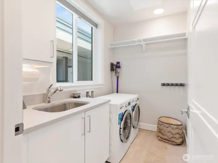 Dedicated laundry room with cabinetry, utility sink and workspace for added convenience. Dedicated laundry room with cabinetry, utility sink and workspace for added convenience.