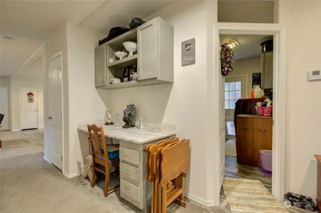 The hallway of the main living area is very spacious and has a study area, door leads to the laundry room!