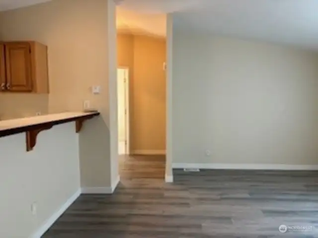 Eating bar off living room with hallway leading into 2 bedrooms/1 bath