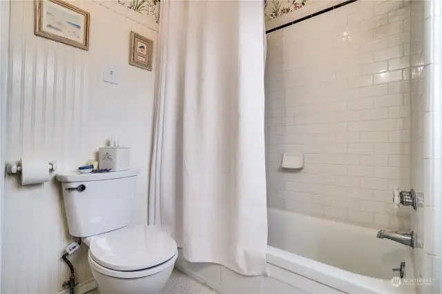 In the full bath, you’ll discover delightful details that harken to a time of true artistry, from the classic subway tile surround and vintage-style fixtures to the sparkling chandelier.