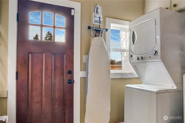 Step into this generous laundry room featuring an updated window and door leading to a serene side patio. Beyond the view, discover ample storage space perfect for home supplies, a pantry, or both!