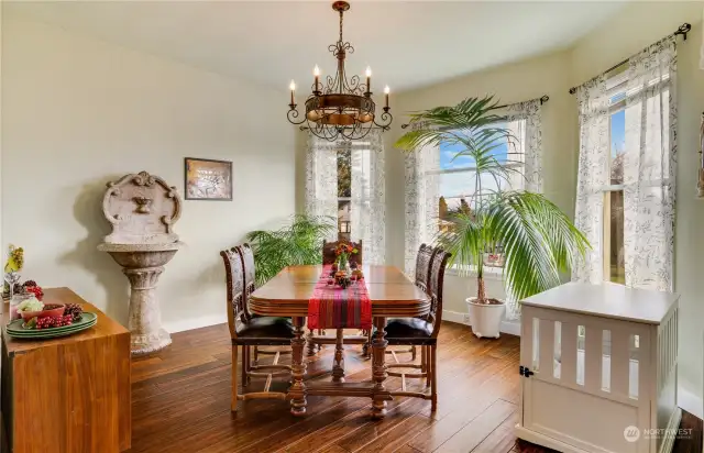 Create an ideal gathering spot for your guests in the dining room where the timeless meets the modern, featuring engineered hardwood flooring and an expansive bay window to bring in the warmth of the day.