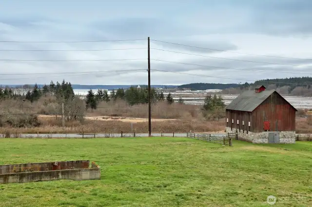 Stunning views of Crescent Harbor. The 2nd lot features a beautifully preserved barn that adds historic charm and endless possibilities, ideal for storage.