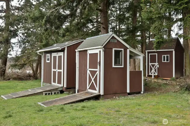 Multiple outdoor sheds for yard tools, gardening, and storage.