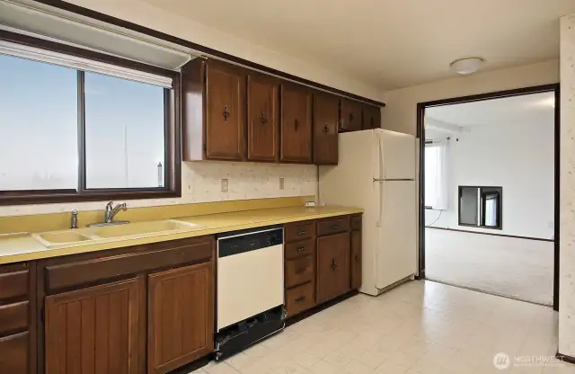 The kitchen with Harbor Views is open to the dining room.