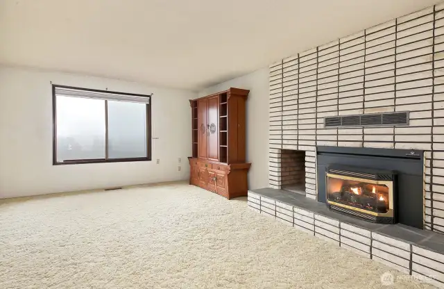 Sitting room with a cozy gas fireplace.