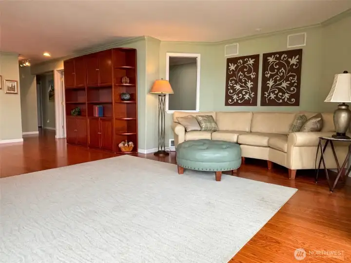 Den/home office looks over living area at the view.