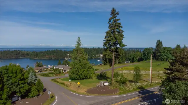 The lot is located where the white Sunrise Cove sign is placed. This half-acre sunny lot has lovely views of Mats Mats Bay and the Cascade Mountains, plus glorious sunrises.
