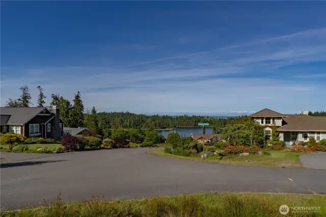 Looking East from the lot, with Mats Mats Bay in the middle of the photo and the Cascade Mountain range in the distance. There are view protection clauses in the CC&R's to protect your views.