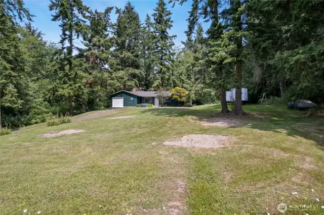 Two parcels; 3.5 acres with area cleared with a charming single family home