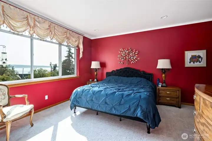 Primary bedroom looks out over the water.
