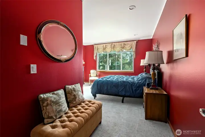 Room for a seating area in the freshly painted primary bedroom.
