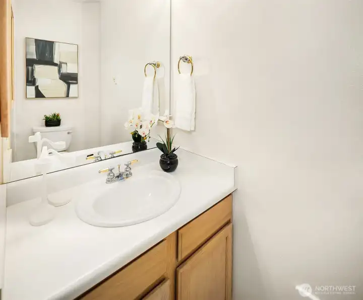 The half bath accessed through the Primary bedroom.