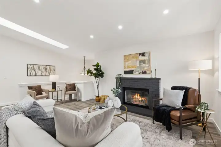 Light-filled living room (upstairs) featuring a cozy fireplace, recessed lighting, and an open-concepts layout ideal for everyday living and entertaining.