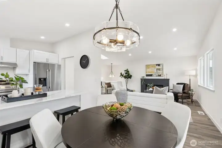 Spacious open-concept floor plan uniting the kitchen, dining, and living areas on the same level - perfect for gatherings and flexible living.