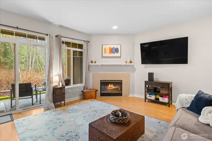 Large sliding glass doors flood the living space with natural light and provide seamless access to the private outdoor patio.