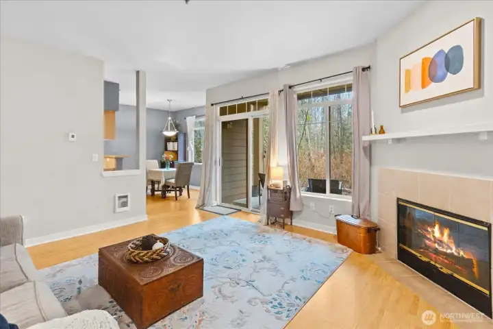 The open-concept living area centers around a cozy tile-surround fireplace and low-maintenance laminate flooring.