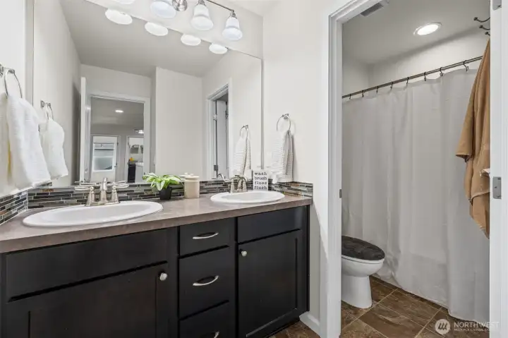 Upstairs main bathroom. Double Vanity, Shower and toilet