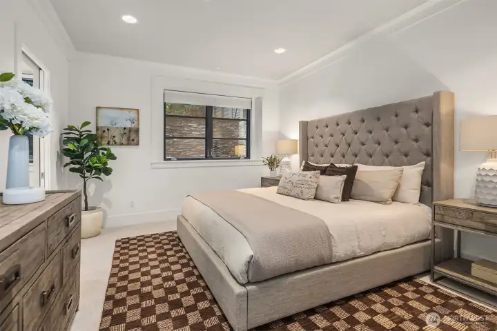 Lower-level bedroom suite with fresh carpet/paint, en-suite bath, and walk-in closet.