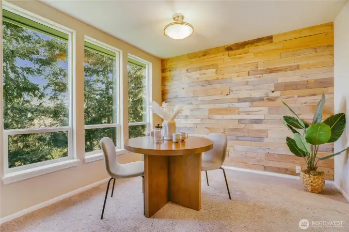 A wall of reclaimed wood gives this dining area style and a feeling of the PNW.