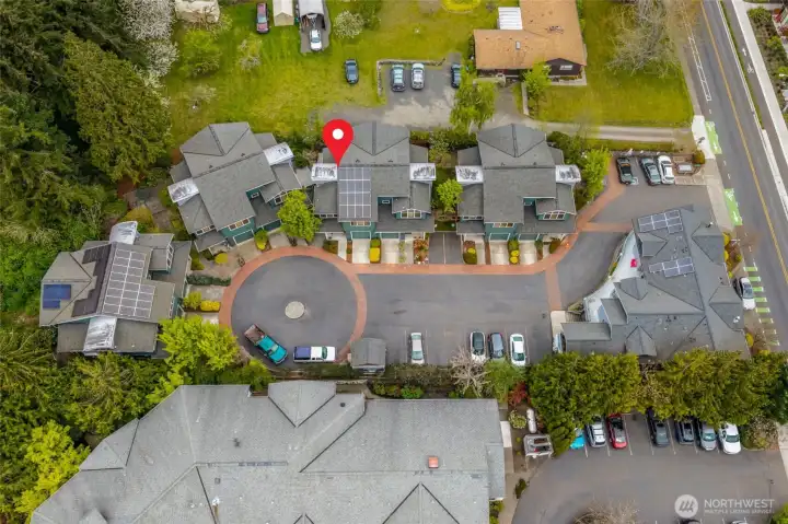 An overhead look at the townhome community — the layout, shared drive, individual garages, and proximity to Madison Avenue.