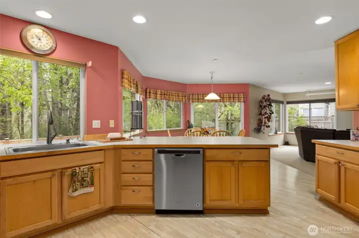 A dining nook is nestled between the kitchen and family room. A slider just beyond the dining table opens to the backyard.