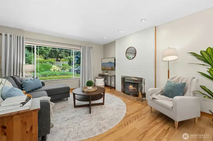 Picture window in living with wood burning fireplace