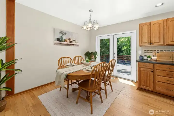 Dining room opens up to large deck for outdoor living through French doors