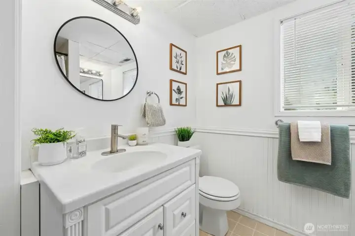 Lower level 3/4 bath with vanity space, extra storage, and linen closet
